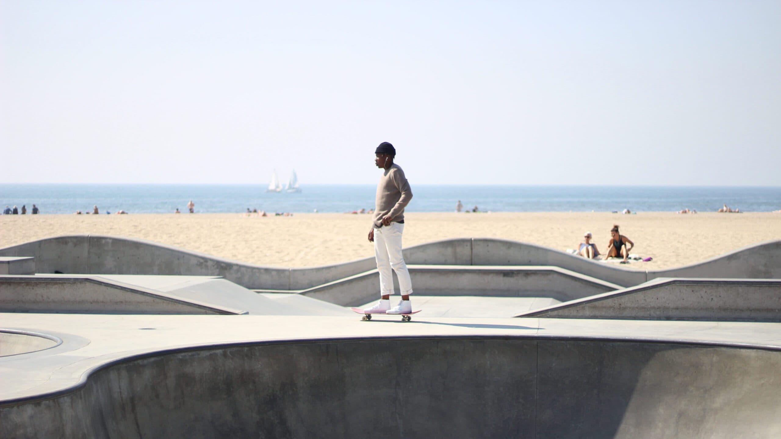 A skateboarder wearing a beanie at the Venice Beach skatepark