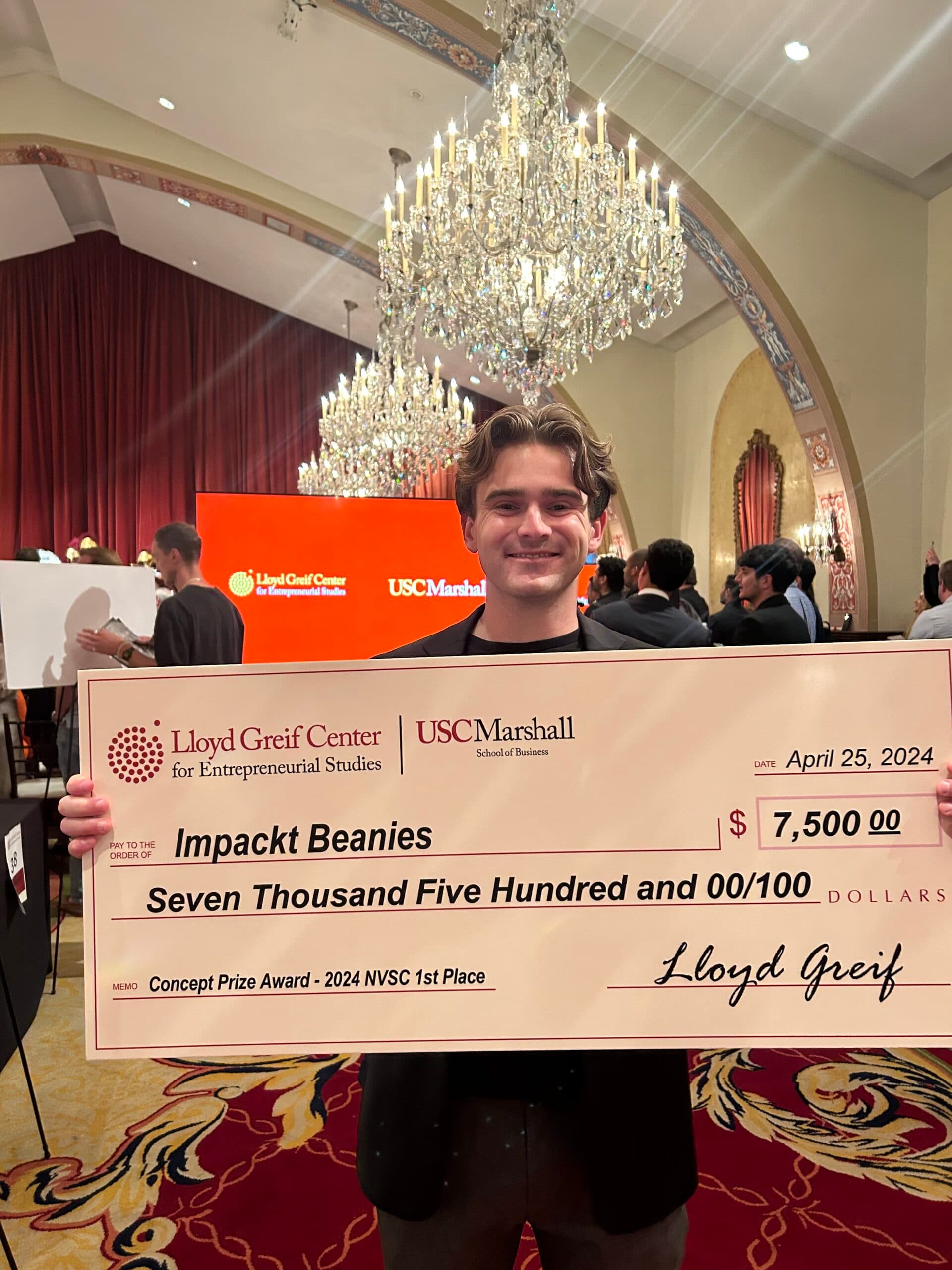 Keith Openshaw holding the $7,500 New Venture Seed Competition award check