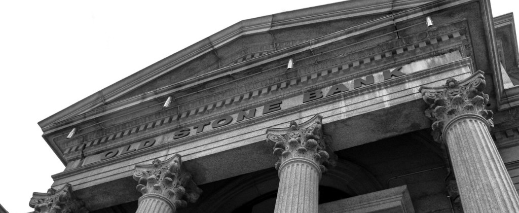 The columns and pediment of Old Stone Bank, photographed from below